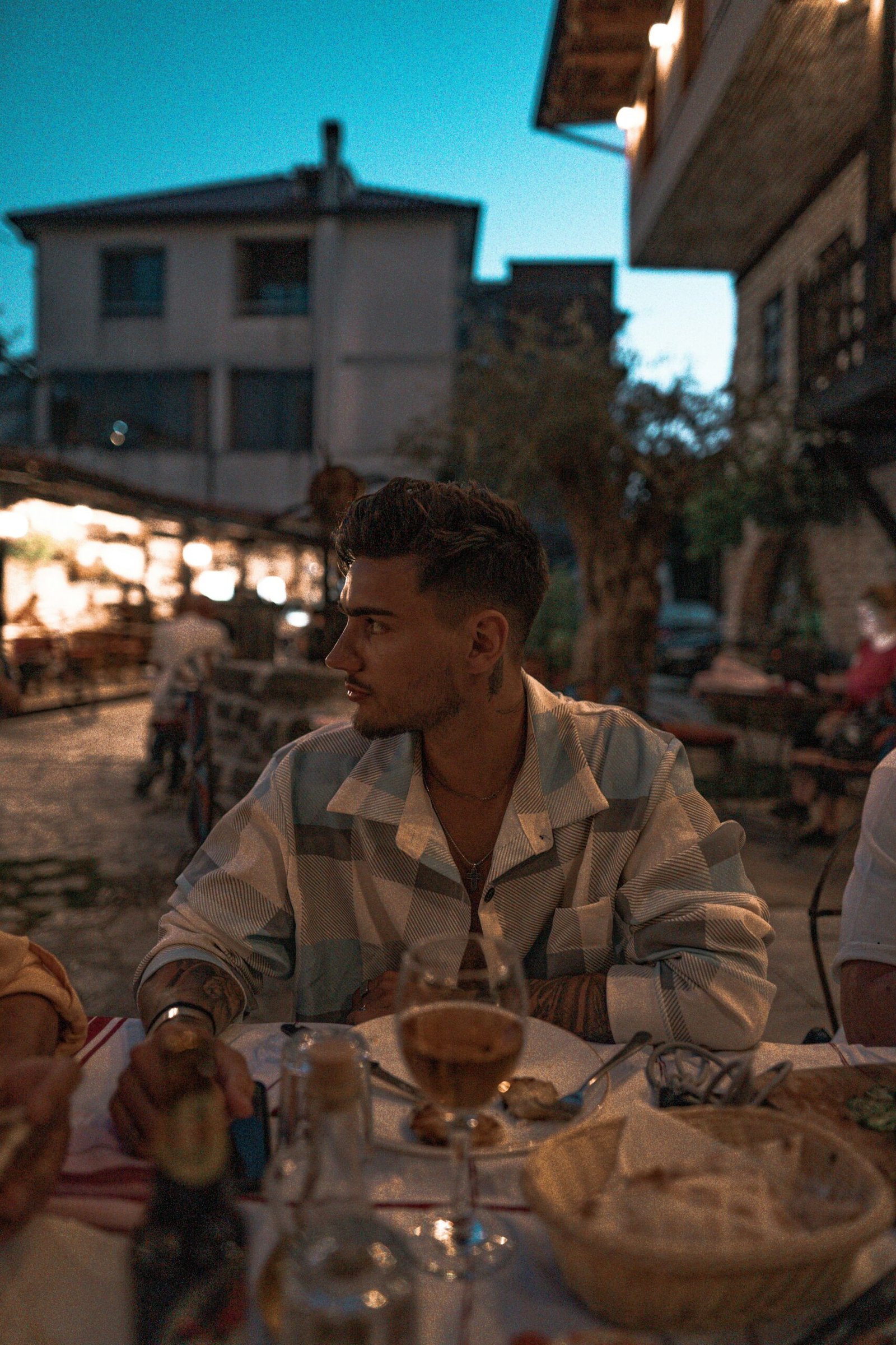 a man sitting at a table outside